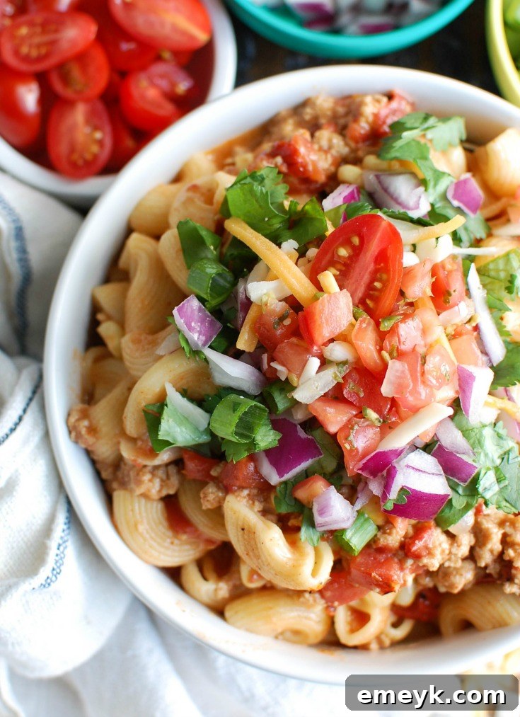 A close-up of Instant Pot Turkey Taco Pasta in a rustic bowl, showcasing the rich sauce and pasta texture.