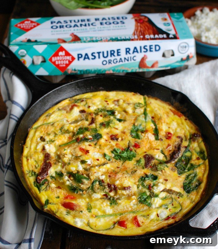 A beautifully cooked Sun-Dried Tomato Goat Cheese Frittata, perfect for a savory breakfast or brunch. It's packed with healthy ingredients like sun-dried tomatoes, spinach, red bell pepper, goat cheese, and eggs, baked to golden perfection.