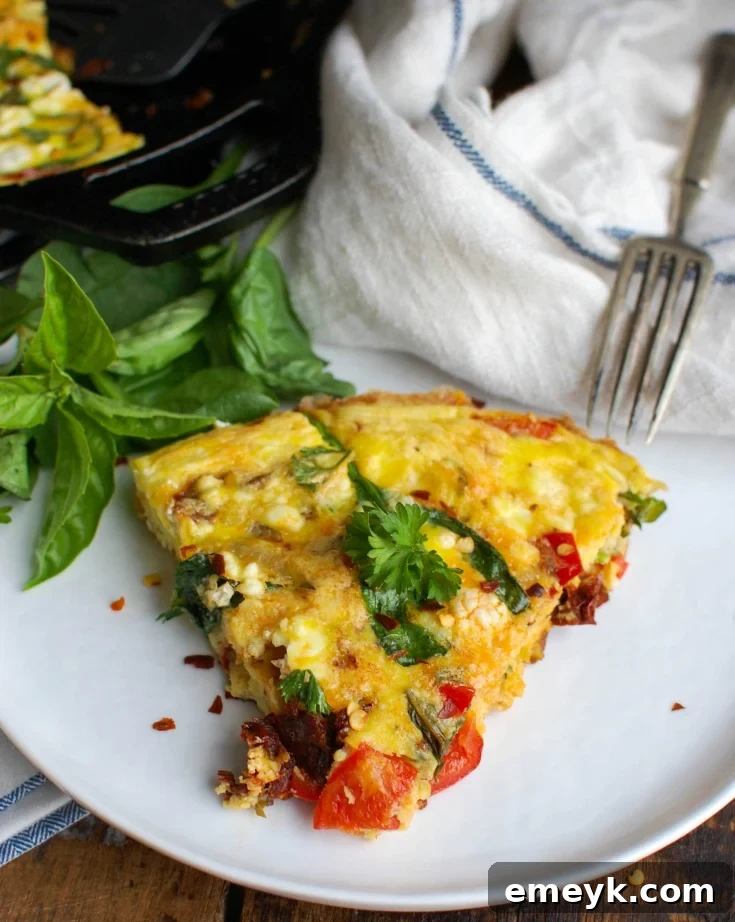 A close-up view of the ingredients for Sun-Dried Tomato Goat Cheese Frittata, showcasing fresh spinach, red bell peppers, and creamy goat cheese, ready to be combined.