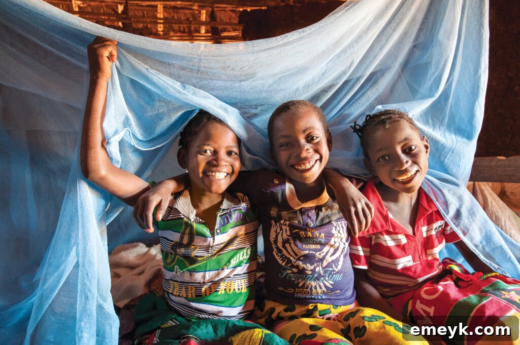 Delfina and friends with a mosquito net from World Vision