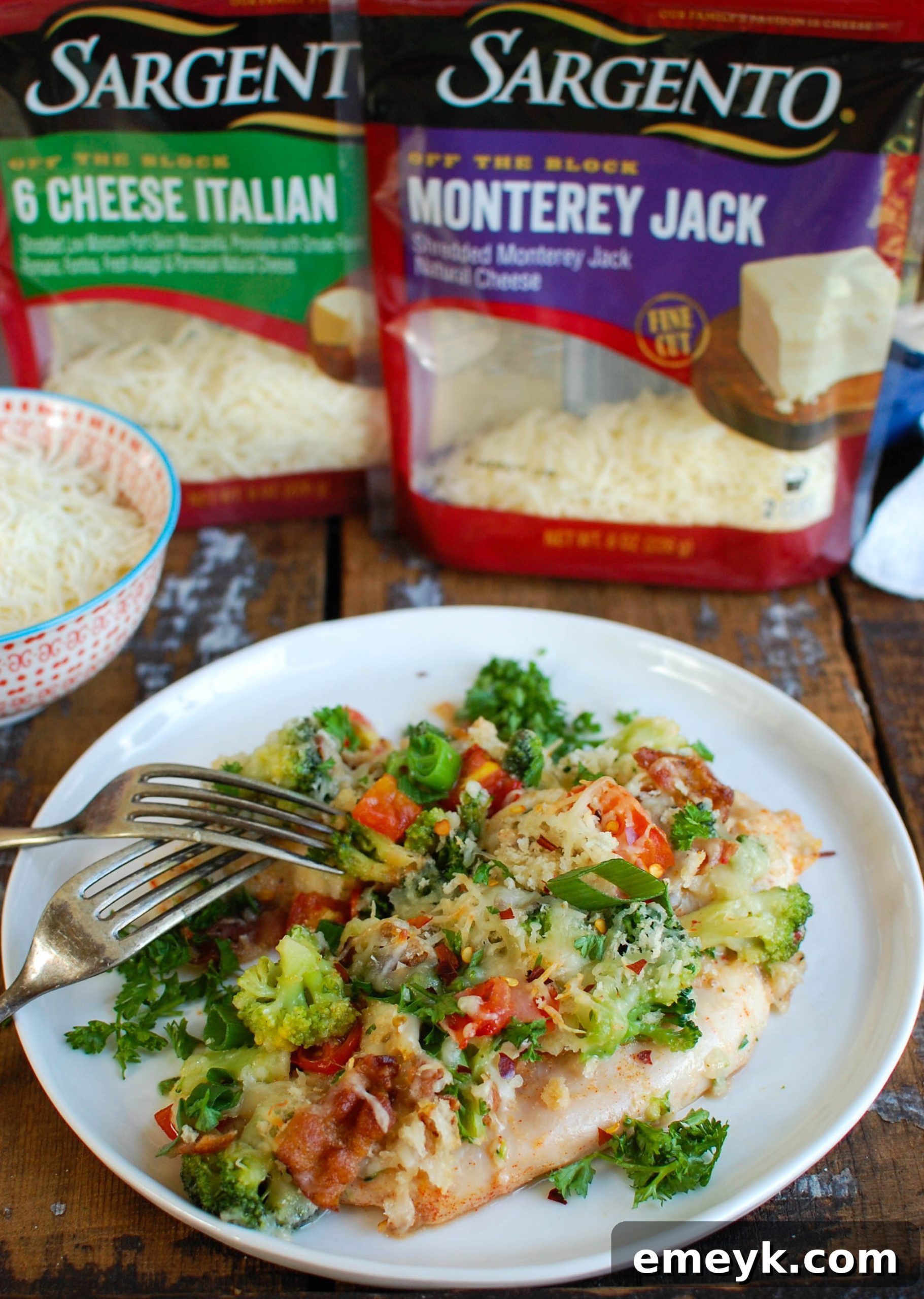 Cheesy Chicken and Broccoli Bake 3 An aerial view of a casserole dish featuring Baked Broccoli Cheese Chicken with melted cheese, crispy bacon, and vibrant green broccoli florets.