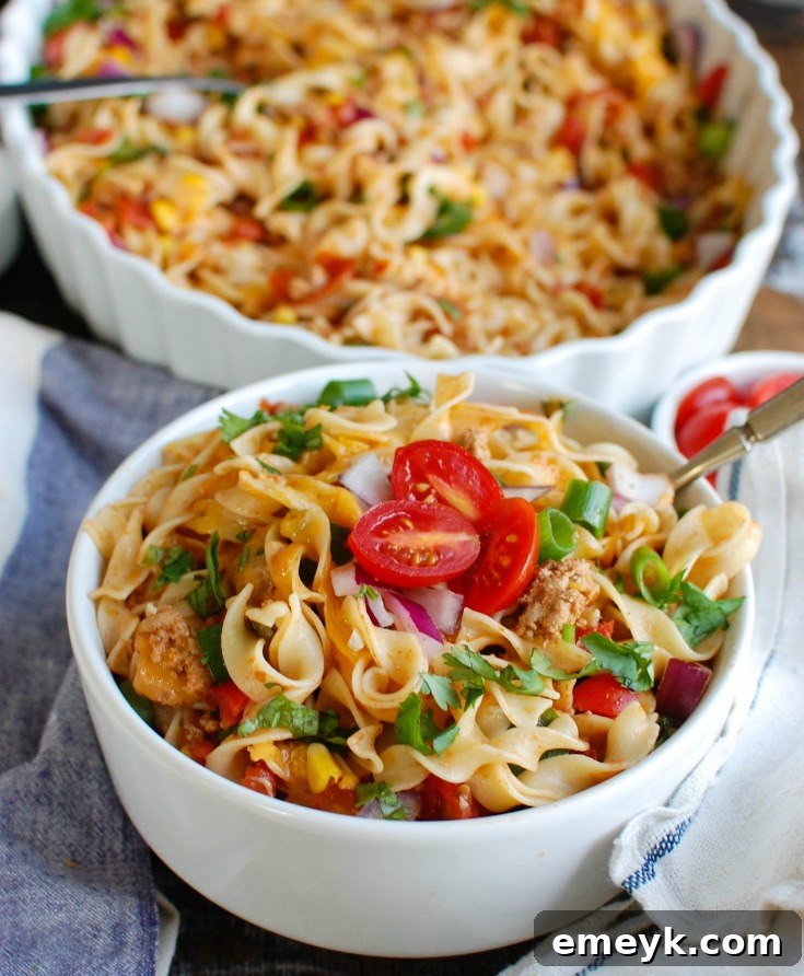 A vibrant and colorful Easy Mexican Noodle Casserole, garnished with fresh cilantro and red onion, making it an inviting weeknight meal.