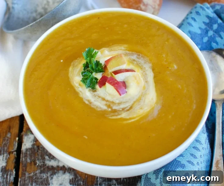 Slow Cooker Butternut Squash Apple Soup with fresh parsley garnish, ready to serve.