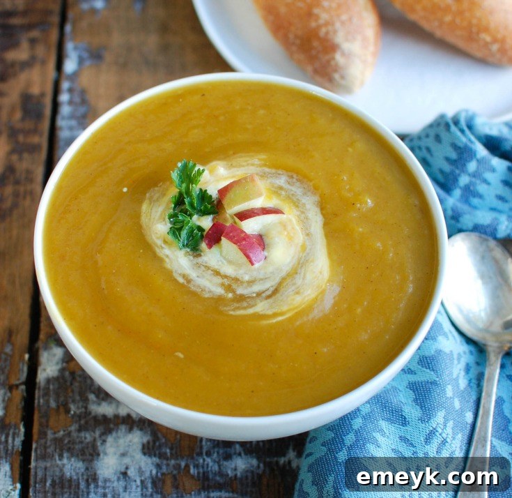 Slow Cooker Butternut Squash Apple Soup with diced apples on top.