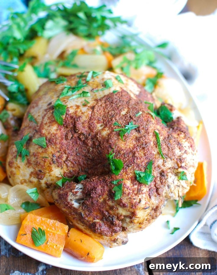 Sun-Kissed Mediterranean Slow Cooker Whole Chicken 2 Tender, juicy Slow Cooker Mediterranean Whole Chicken served with vibrant jeweled rice, garnished with fresh herbs.