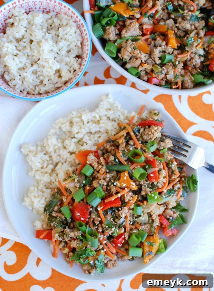 Fresh ingredients laid out for Easy Thai Pork Stir-Fry, including ground pork, a variety of colorful vegetables, and sauce components