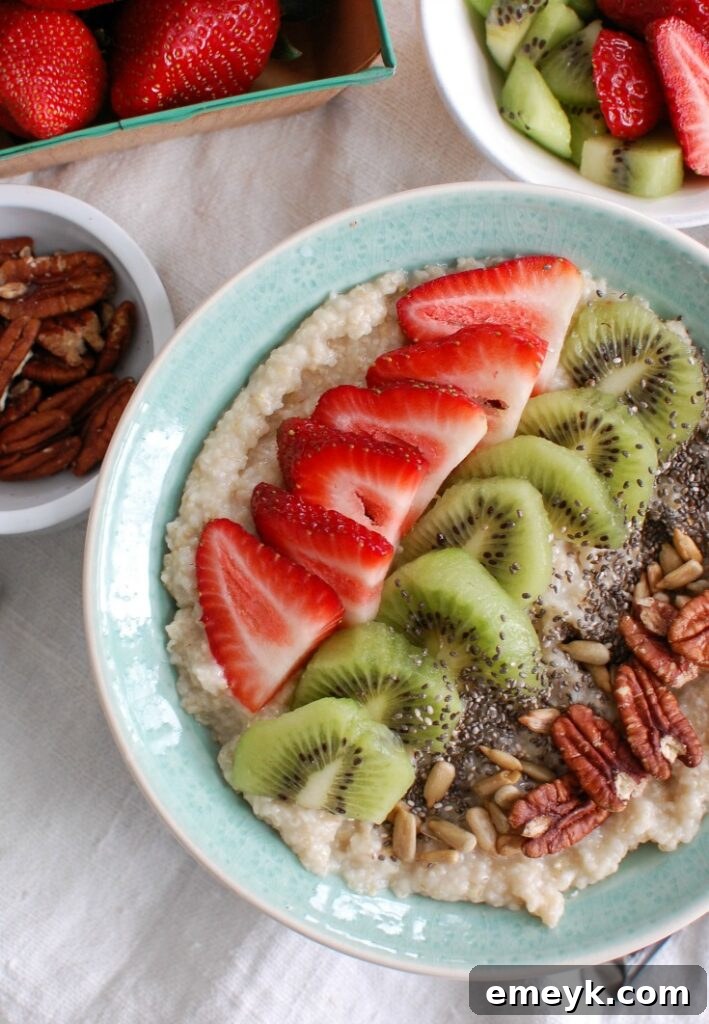 A beautifully prepared Strawberry Kiwi Chia Seed Oat Bran Bowl, topped with fresh strawberries, kiwi slices, and a sprinkle of chia seeds, presented in a rustic bowl on a wooden surface.