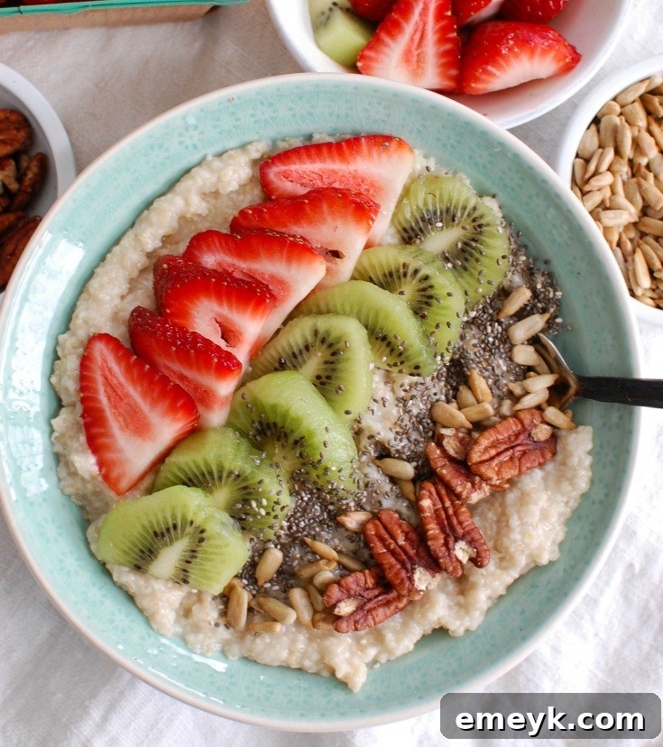 A close-up of colorful fresh kiwi and strawberry slices perfectly arranged, glistening and ready to be added as vibrant toppings to an oat bran bowl.