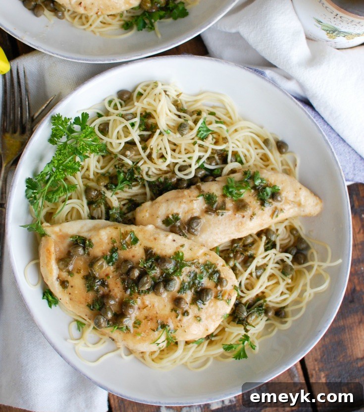 Zesty Lemon Caper Chicken 4 A close-up view of a perfectly cooked Chicken Piccata, showing the rich, golden-brown chicken breast and the glistening lemon-caper sauce.