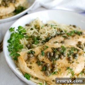 Easy Chicken Piccata with lemon slices and capers, ready to serve.