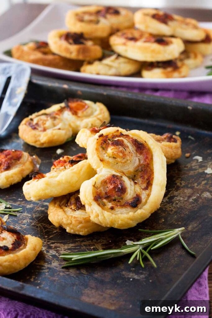 Easy puff pastry ‘palmiers’ stuffed with tasty sun-dried tomatoes, parmesan & fresh rosemary.