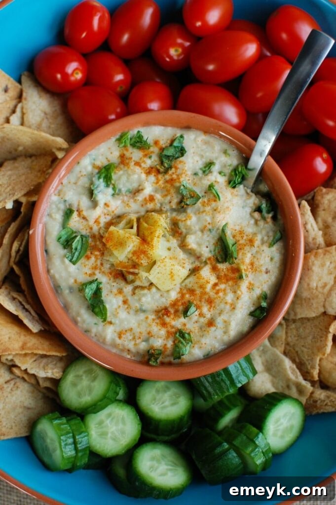 White Bean Artichoke Dip is a healthy appetizer, snack or spread for sandwiches. White beans, artichokes, lemon juice, olive oil, cayenne pepper, basil and garlic are blended and topped with fresh basil and parsley to create a healthy, flavorful dip.