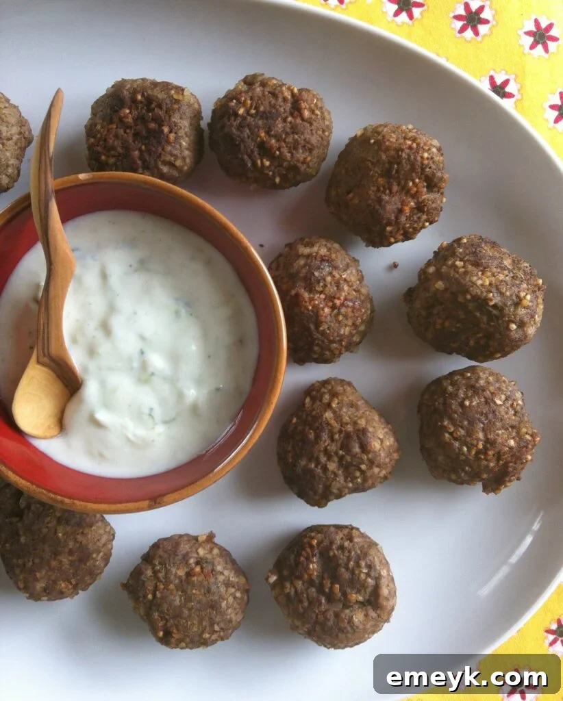 Kibbeh Meatballs With Spiced Yogurt Sauce is a delicious Lebanese appetizer or main dish recipe that’s traditionally made with ground lamb. These easy meatballs are made with beef, with Lebanese spices.