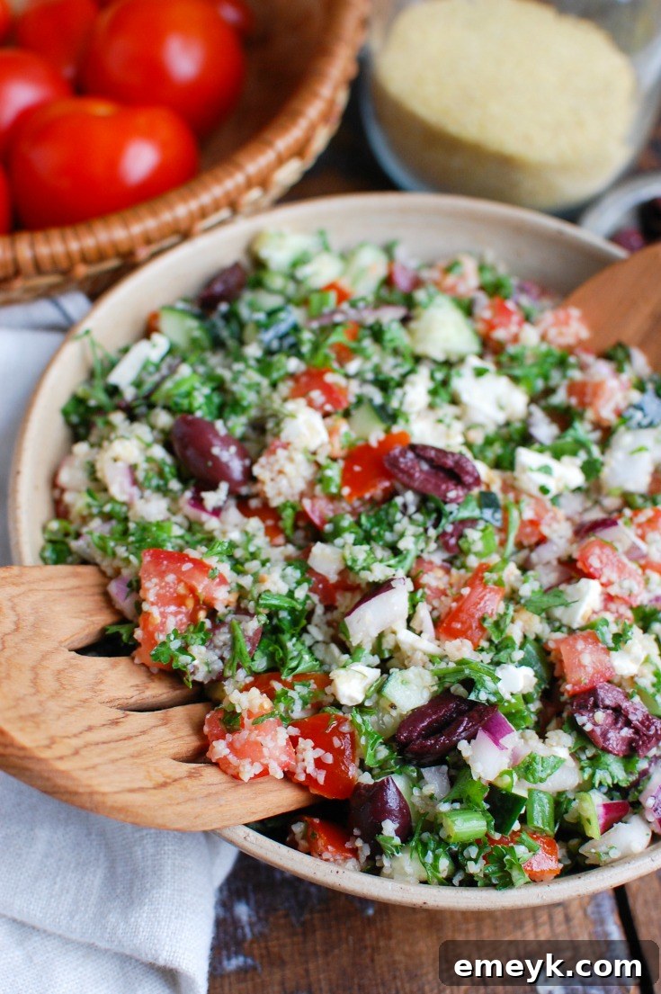 Greek Tabbouleh being prepared, with a focus on fresh tomatoes, ready to be mixed into the salad.