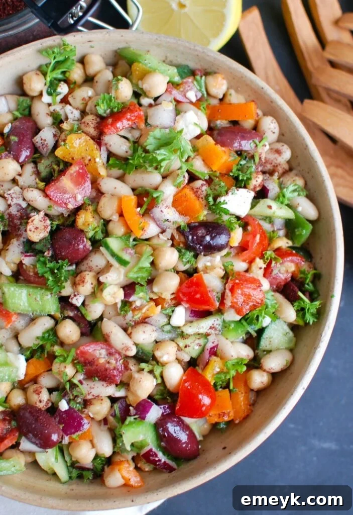 Freshly prepared Mediterranean Bean Salad in a large glass bowl, ready to be served.