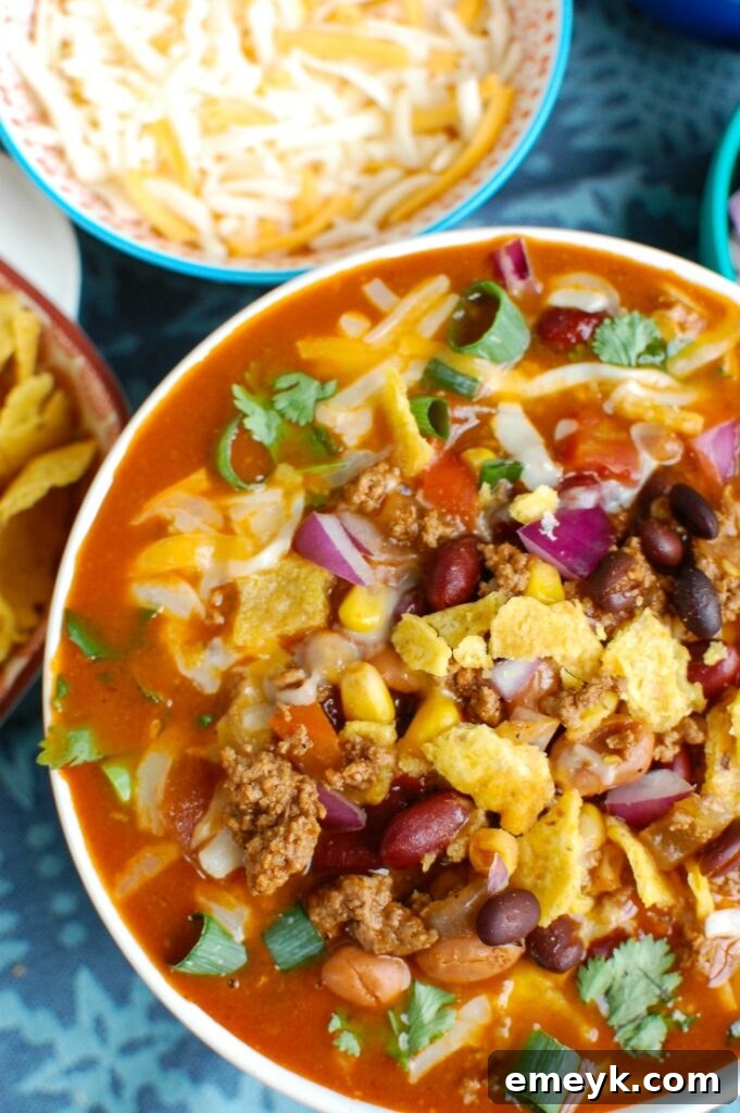 Zesty Instant Pot Taco Soup 4 Instant Pot Taco Soup in a white bowl, garnished with fresh cilantro and lime wedges, showcasing its vibrant colors.