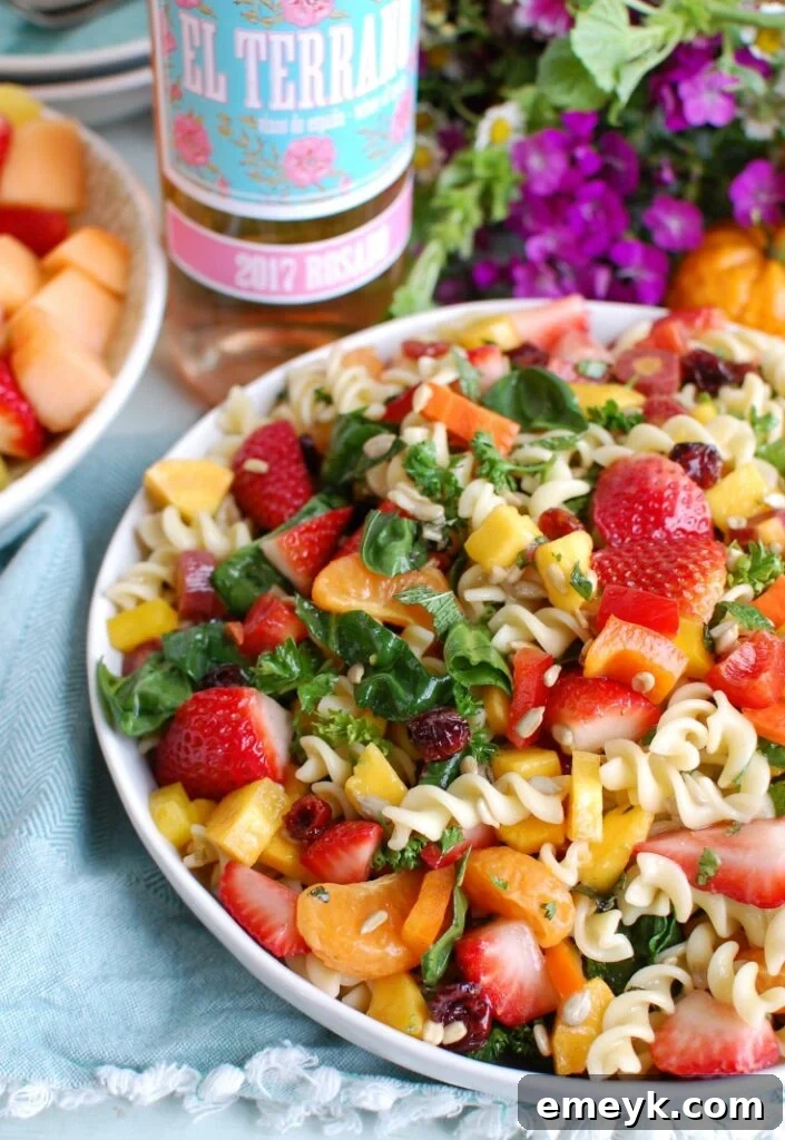 Bright Spring Pasta Salad 3 Spring Pasta Salad served in a bowl next to a glass of rosé wine, emphasizing its perfect pairing for spring brunches and celebrations.