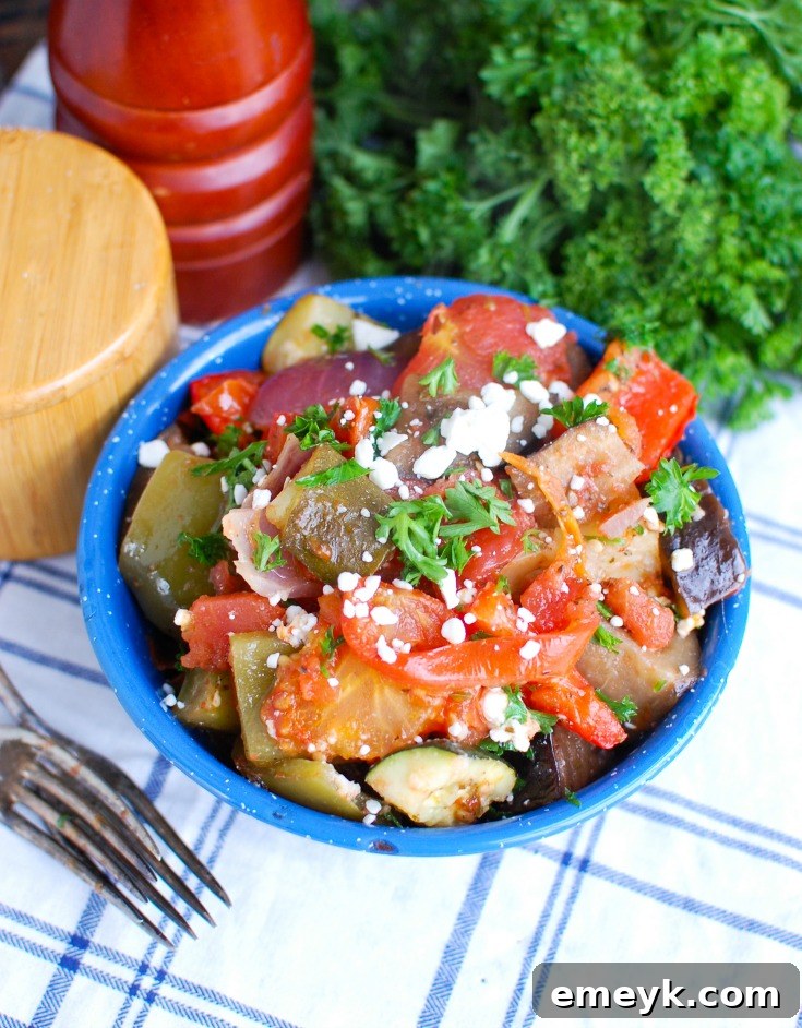 Greek Roasted Vegetables {Briami} are tender, flavorful vegetables that are roasted in a tomato based sauce and topped with fresh parsley and feta cheese. These vegetables work great over rice, paired with pasta or as a side dish to your meal.