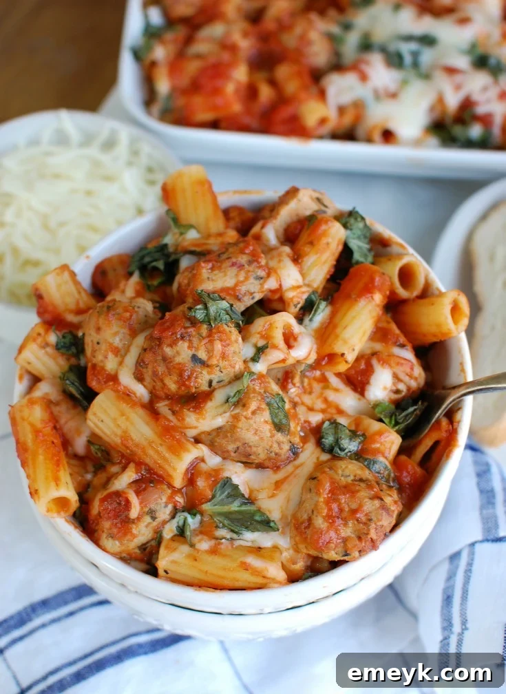Hearty Chicken Meatball Rigatoni Casserole 5 Serving of Easy Baked Rigatoni with Chicken Meatballs in a white bowl