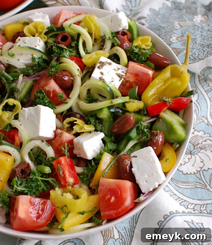 Spiralized Greek Style Salad in a white bowl, ready to be served