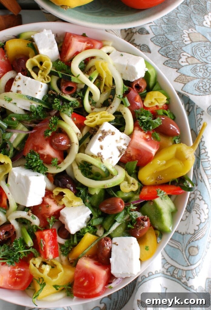 Spiralized Greek Style Salad with a neatly folded napkin, showcasing its fresh appeal