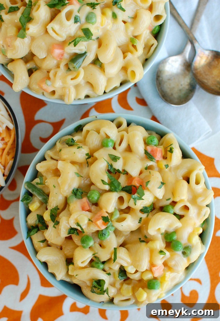 A single serving of Instant Pot Vegetable Mac and Cheese in a charming blue bowl, ready for serving.