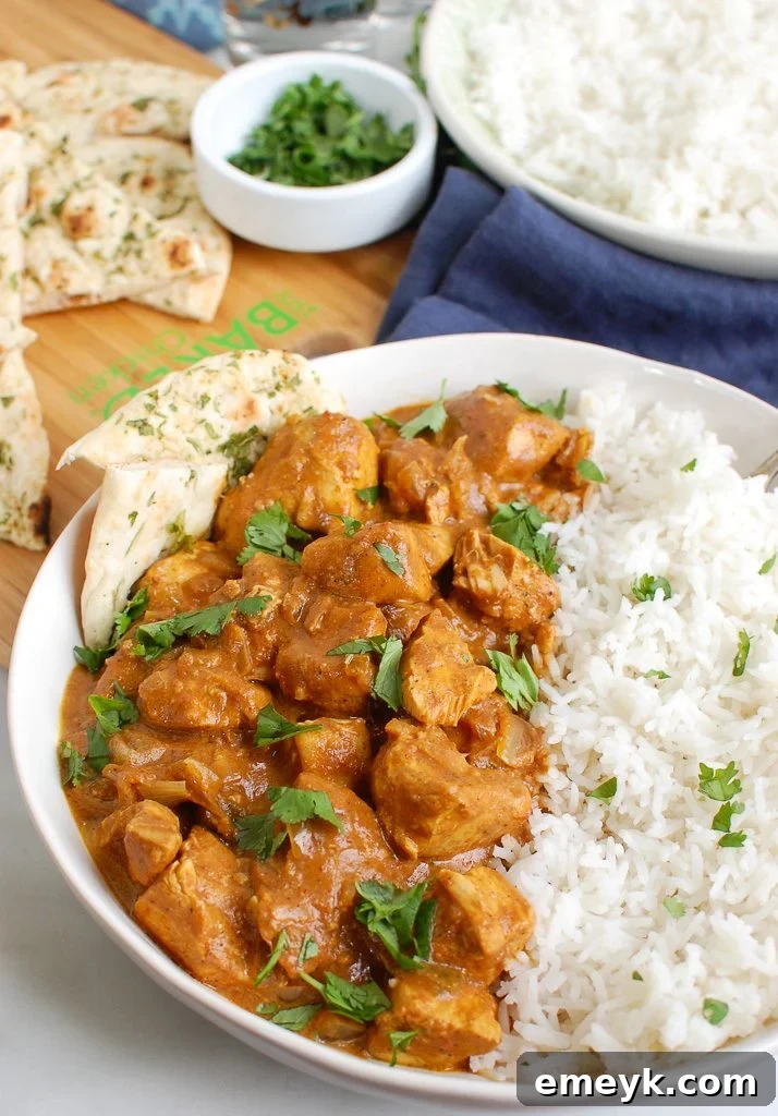 Slow Cooker Butter Chicken in a white bowl, ready to serve.