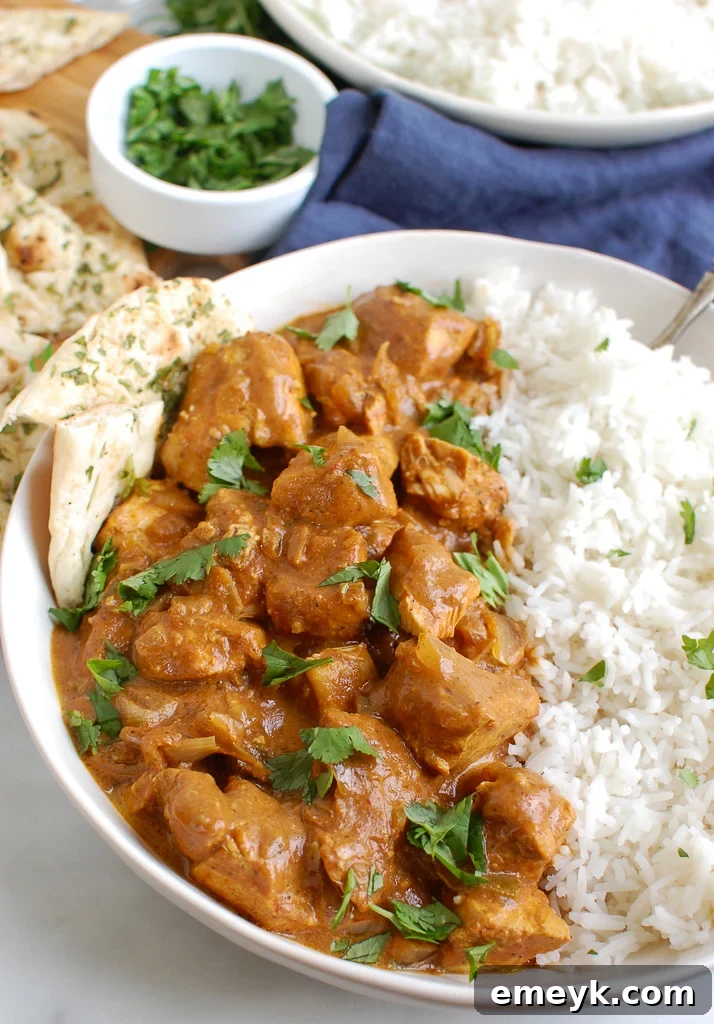 Slow Cooker Butter Chicken served with warm naan bread.