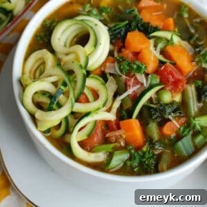 Spring Vegetable Minestrone, top-down view in a white bowl, showing fresh ingredients.