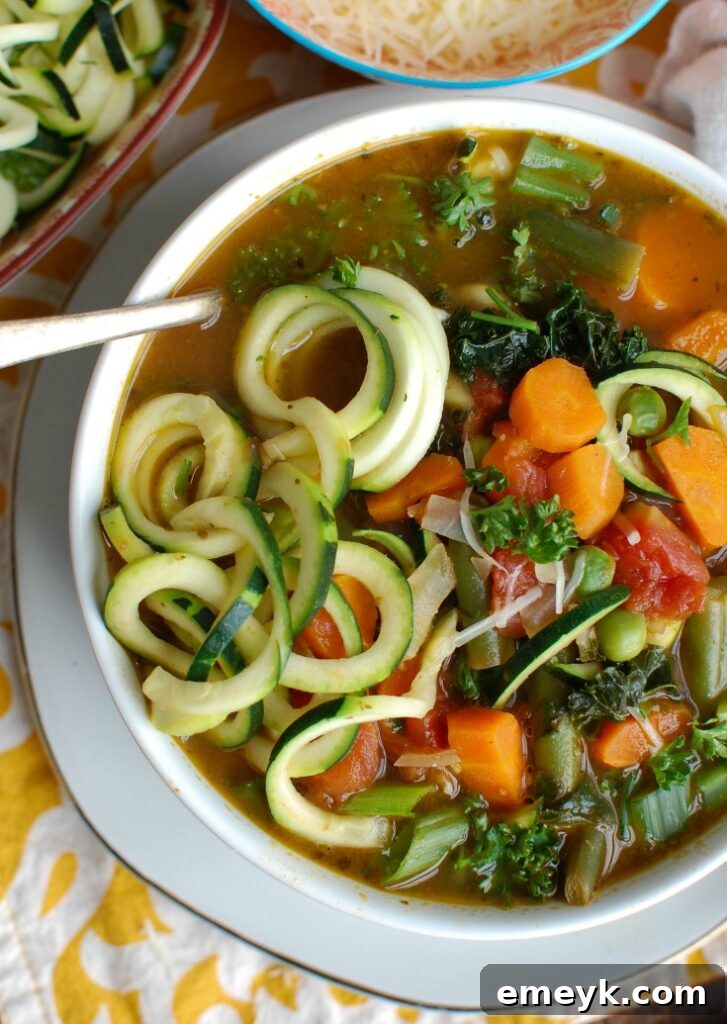 Garden Fresh Spring Minestrone 3 Spring Vegetable Minestrone, close-up aerial view, highlighting the colorful medley of vegetables and zucchini noodles in a rich broth.