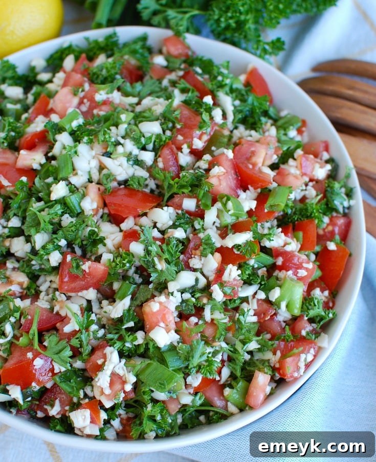 Grain-Free Cauliflower Tabbouleh 2 Vibrant Cauliflower Tabbouleh salad served in a decorative bowl, ready to be enjoyed.