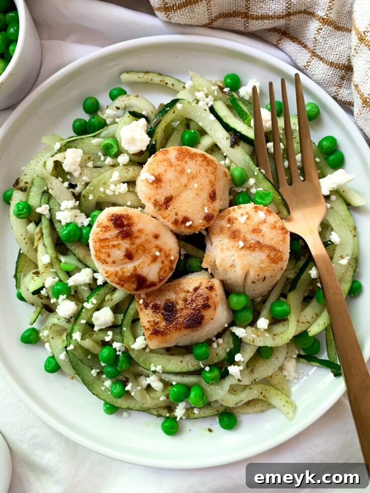 Garlic Seared Scallops with Pesto Zoodles, an elegant and quick seafood meal.
