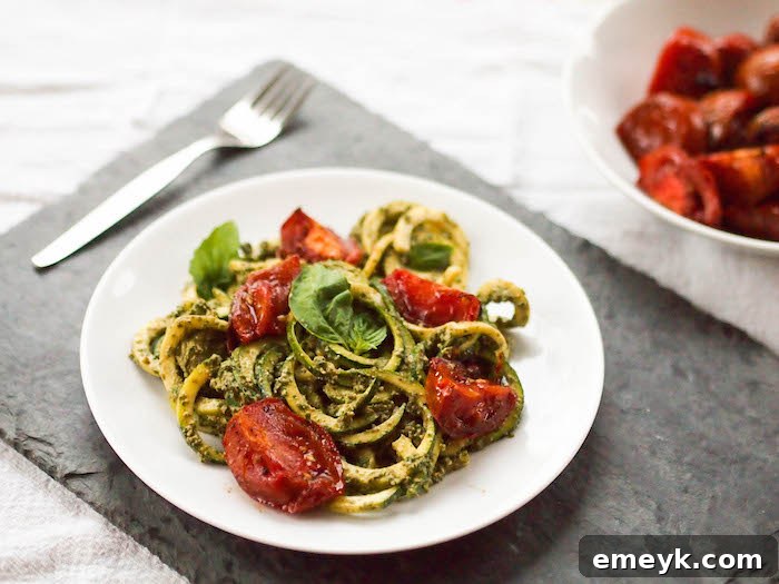 Zoodles with Creamy Vegan Pesto and Roasted Tomatoes, a flavorful plant-based meal.