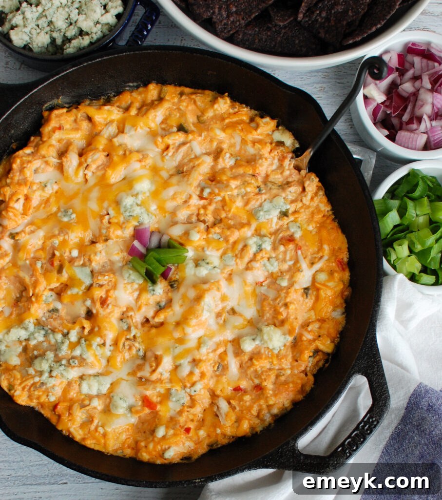 Buffalo Chicken Queso Cheese Dip Skillet - The perfect game day appetizer bubbling with flavor, served in a rustic skillet.