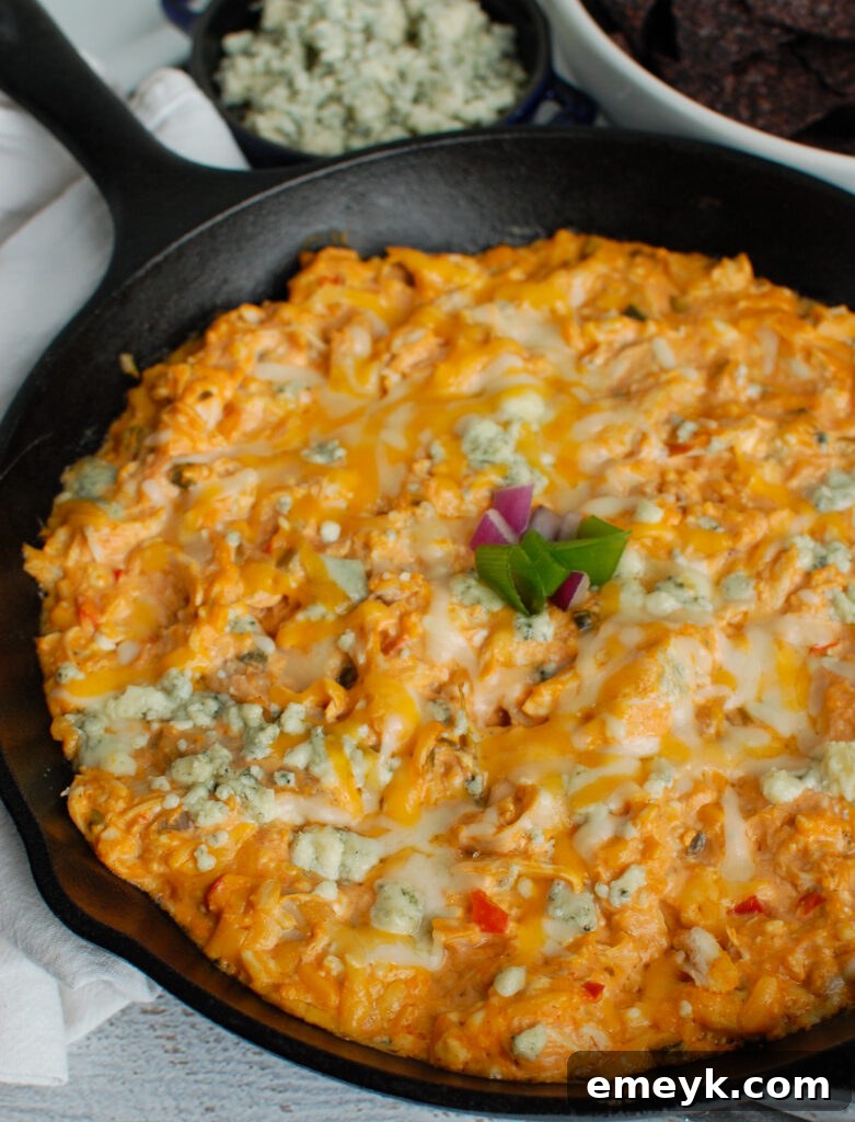 Buffalo Chicken Queso Cheese Dip served with dippers like celery sticks and tortilla chips, ready to be enjoyed.