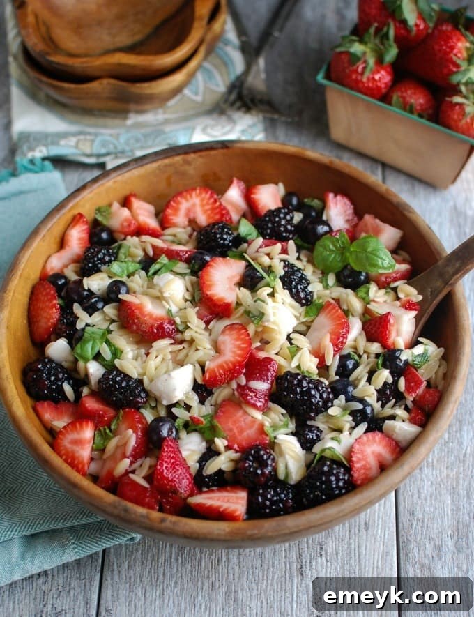 9 Ultimate Orzo Pasta Salads 11 A unique Mixed Berry Caprese Orzo Salad, featuring fresh berries, mozzarella balls, basil, and balsamic glaze, a sweet and savory delight.