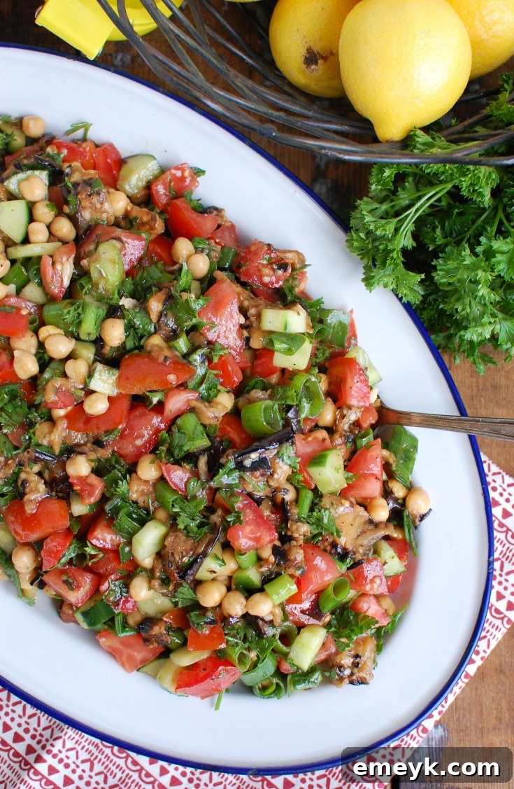 Mediterranean Eggplant Chickpea Salad presented on a beautiful white and blue platter, ready to serve