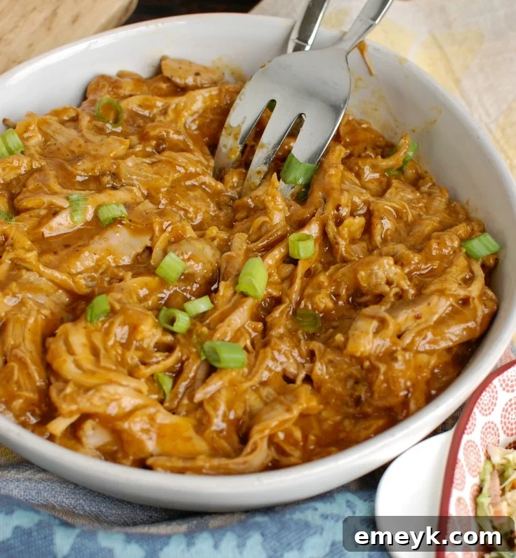 Shredded Slow Cooker Pork Tenderloin ready to be served in a bowl.