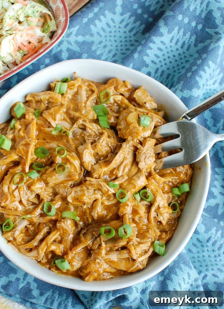 Slow Cooker Pork Tenderloin served in a bowl with a fork, ready to eat.