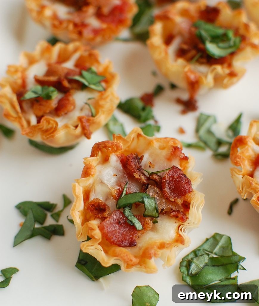 Close-up of Bacon Pizza Bites, garnished with fresh basil leaves