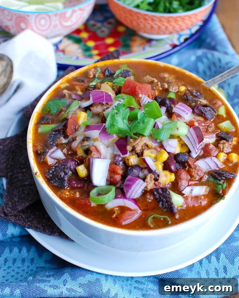 A serving of Instant Pot Turkey Chili with a spoon, highlighting its thick and hearty texture.