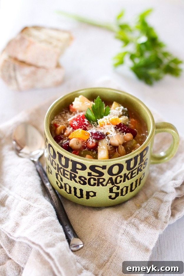 Wholesome Slow Cooker Minestrone Soup brimming with fresh vegetables, pasta, and beans in a rich tomato broth.