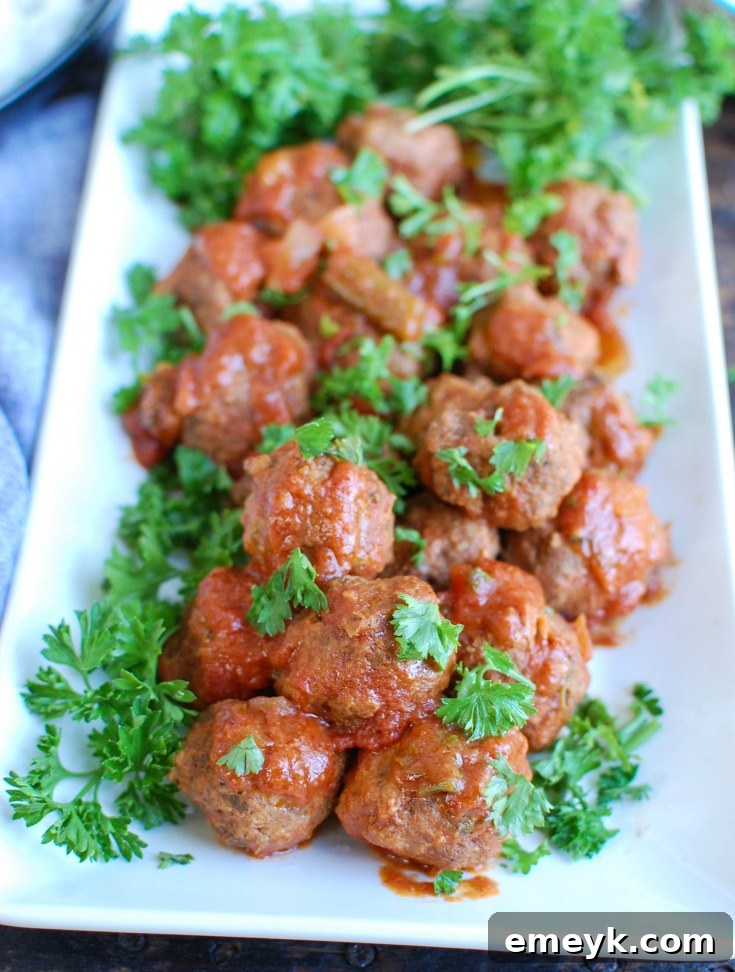 Slow Cooker Mediterranean Beef Meatballs simmered with Lebanese Green Beans in a flavorful sauce, seasoned with warm Mediterranean spices.
