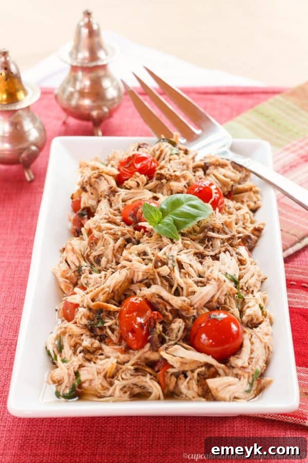 Flavorful Slow Cooker Tomato Basil Pulled Chicken, perfect for versatile meals.