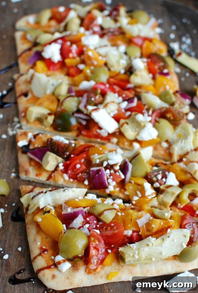 Plant-Powered Plates: 20 Recipes for Peak Energy and Vitality 14 Mediterranean Flatbread with hummus, olives, artichokes, and feta cheese.