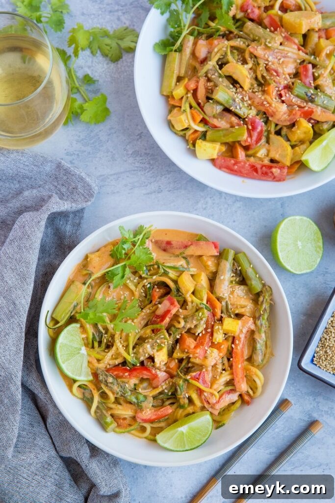 Plant-Powered Plates: 20 Recipes for Peak Energy and Vitality 18 Vegan Red Curry Zucchini Noodle Bowls, showcasing a rich red curry broth with zucchini noodles and vegetables.