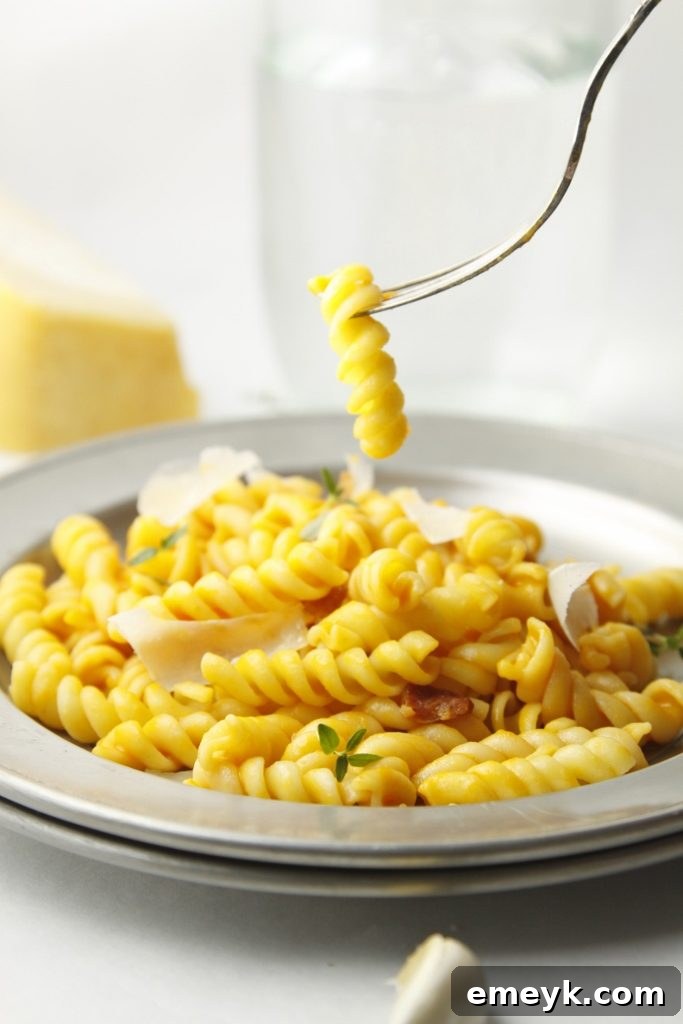 Plant-Powered Plates: 20 Recipes for Peak Energy and Vitality 4 Creamy Carrot & Parmesan Pasta, a vibrant orange pasta dish topped with fresh parsley.