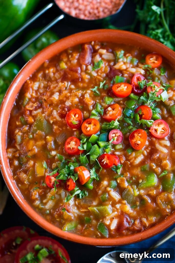 Plant-Powered Plates: 20 Recipes for Peak Energy and Vitality 8 Vegan Stuffed Pepper Soup in a rustic bowl, garnished with fresh basil leaves.
