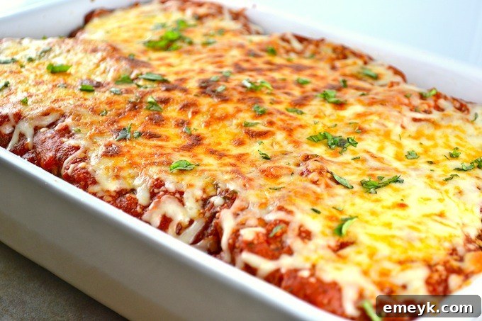 Plant-Powered Plates: 20 Recipes for Peak Energy and Vitality 9 Layers of golden brown Eggplant Parmesan, baked to perfection with cheese and tomato sauce.