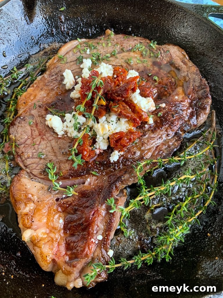 Pan-Seared Ribeye with Goat Cheese and Sun-dried Tomatoes in Skillet